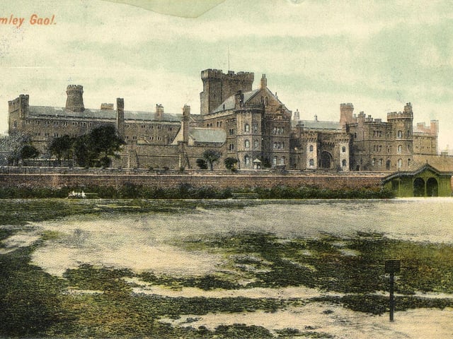 An undated postcard view of Armley Jail taken from the recreation ground in front. It opened in 1847 and cost £43,000. This was for the land and the buildings. The green structure to the right of the brick wall is a shelter built in the recreation ground and marked on a map dated 1908. Between the building of the prison and the wall of the recreation ground the 'jail field' can just be seen.