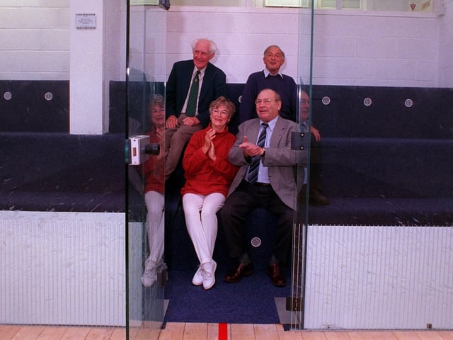 Adel Memorial Institute committee members try out the seating in the new glass backed squash court in September 1999.