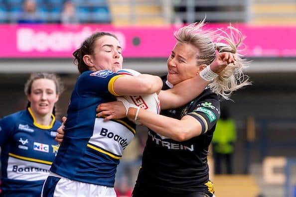 Sophie Nuttall, pictured being tackled by York's Tara Jane Stanley at Headingley in April, is ruled out of Rhinos' side for Sunday's Cup semi-final. Picture by Allan McKenzie/SWpix.com.