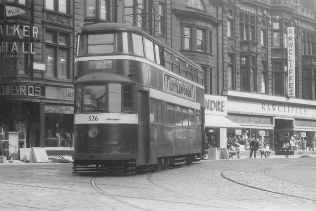 A view of Duncan Street showing tram no.536 which has just come from Lower Briggate on the way to Halton by route 20 in September 1957. Shops visible in the background are Walker & Hall Ltd., jewellers, Reid Bros. Ltd., tailors. Alexandre Ltd., tailors, and Rawcliffes Ltd., clothiers. Tram no.536 is one of the ex-London 'Feltham' trams which came to Leeds in 1950.