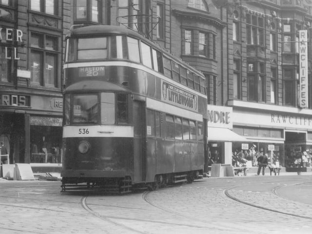 A view of Duncan Street showing tram no.536 which has just come from Lower Briggate on the way to Halton by route 20 in September 1957. Shops visible in the background are Walker & Hall Ltd., jewellers, Reid Bros. Ltd., tailors. Alexandre Ltd., tailors, and Rawcliffes Ltd., clothiers. Tram no.536 is one of the ex-London 'Feltham' trams which came to Leeds in 1950.