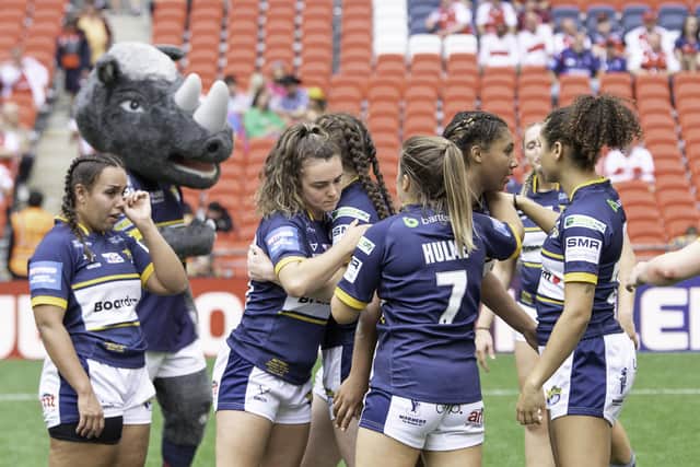 Leeds console themselves after defeat to St Helens. (Photo: Allan McKenzie/SWpix.com)