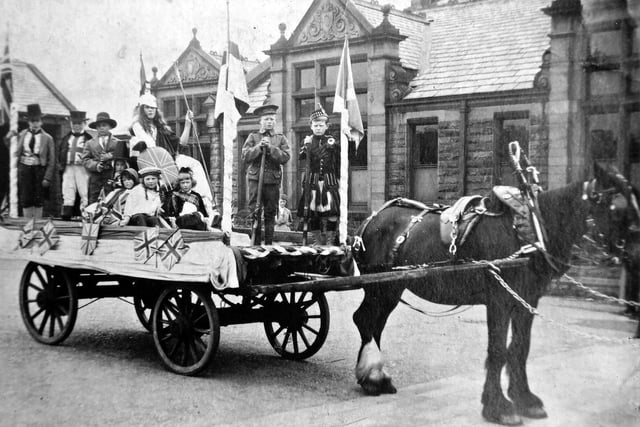 As the Armistice for ending the First World War came into force at the eleventh hour on the eleventh day of the eleventh month of 1918, so the float shown here getting ready to join a procession had a similar number relationship. The float is in Victoria Road School playground and represents the British Armed Services. All the schools of Morley provided floats on different themes connected with the Great War. Altogether there were 19 floats pulled by 19 horses to celebrate the signing of the Peace Treaty (Treaty of Versailles) which came into force on June 19, 1919, when most places in the country organised a similar event to commemorate the proceedings. An official programme was printed and the procession took an organised route through the town, passing close to the schools which contributed to it - Morley Secondary School, Cross Hall, Bridge Street, Peel Street, Victoria Road and St. Peter's but not as far as Churwell. The procession came to a conclusion with a choir of schoolchildren singing appropriate hymns.