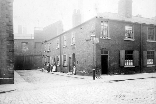 Sovereign Street taken in July 1902. It was named after Queen Victoria. This view is of William Court. First right is arched entrance to Bow Yard. House facing front on Sovereign Street is number 17.