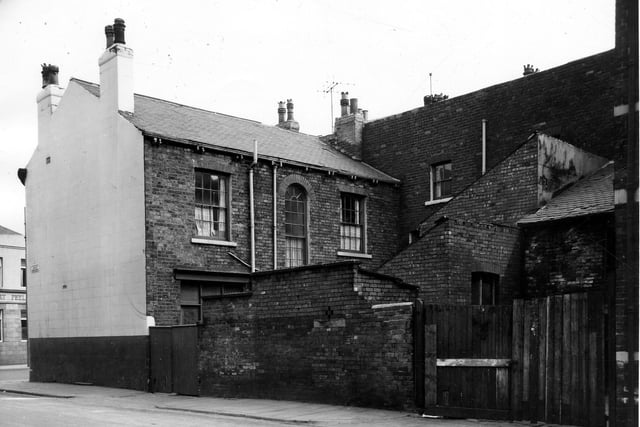 The rear of the Silver Cross pub on Derby Crescent in May 1964 showing wooden gates at the entrance to a yard with out-buildings. The famous Silver Cross pram manufacturers started in this area in 1877 with the original small premises in Silver Cross Street.