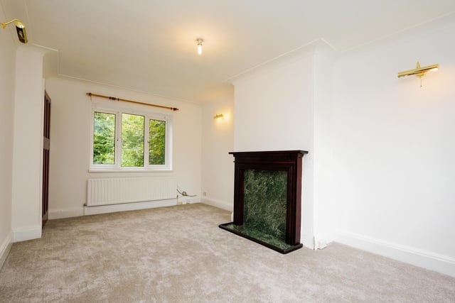 Downstairs, a spacious lounge boasts beautiful windows to the front and rear, with a feature fireplace included.