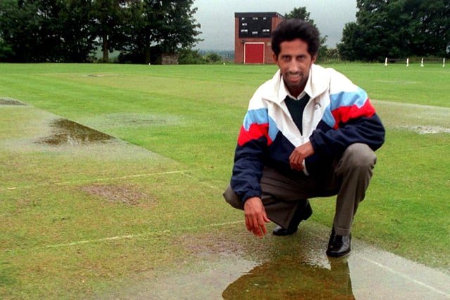 Gildersome captain, Yakub Valli, points out one of the damp patches on the pitch marked out for their game against Batley which had to be abandoned in June 1997.