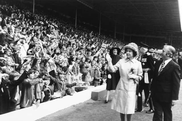 The Queen waves to youngsters at Elland Road in July 1977.