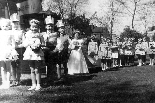 Children taking part in the Armley May Queen procession, seen outside Christ Church Upper Armley C 0f E Church situated on Armley Ridge Road. The May Queen, in the centre in the long dress, is Sandra Ford, born in 1950, daughter of Allen Ford of the Far Fold area of Armley.