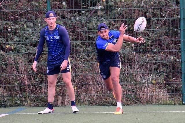 Leeds Rhinos winger David Fusitu'a passes the ball at training as his centre Harry Newman watches on. Picture by Simon Hulme.