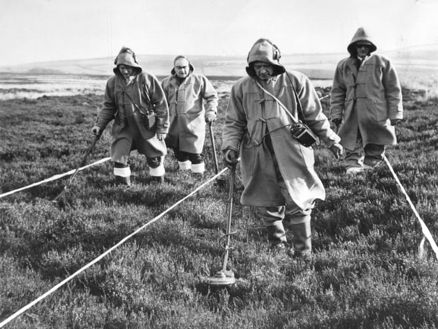 A Bomb disposal team from Scarborough check a section of Pock Stone Moor near Pateley Bridge in February 1970. Pictured with detectors are Malcolm Cox, left, and Joe Collins. Behind with spades Ronald Stead, left, and Charles Dimittrijevic.