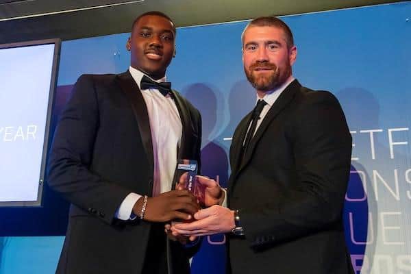 Sam Eseh, left, receives his 2022 Championship young player of the year award from former Wakefield prop Kyle Amor. Picture by Allan McKenzie/SWpix.com.