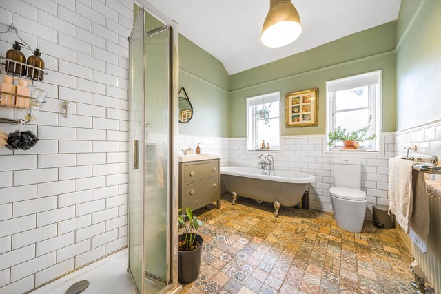 The house bathroom is a large four-piece suite with a roll-top bath, separate shower, toilet and hand basin. There are two rear-facing windows, feature pattern tiles and it is all finished to a good standard.