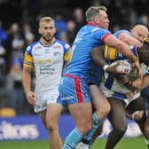 Wakefield's Matty Ashurst tackles Rhinos' Justin Sangare. Picture by Steve Riding.