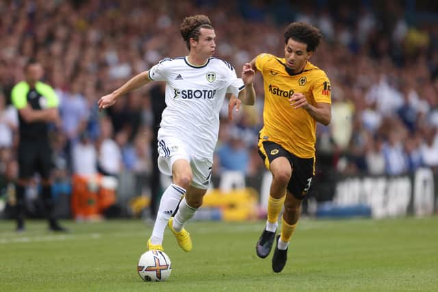 ON THE MOVE: New Leeds United star Brenden Aaronson, left, comes forward as Wolves defender Rayan Ait-Nouri looks to keep tabs on the USA international midfielder in Saturday's Premier League clash at Elland Road. Photo by Marc Atkins/Getty Images.