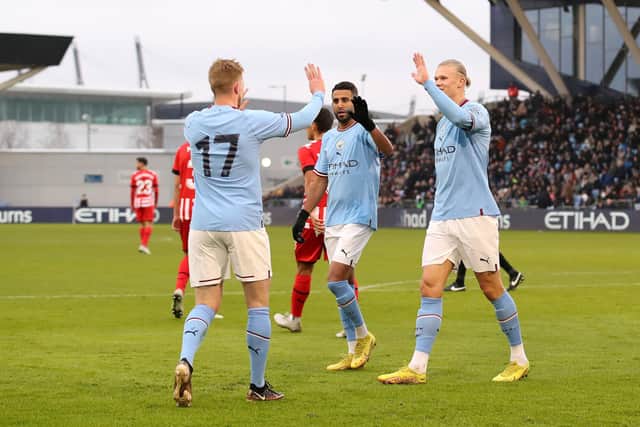 MANCHESTER, ENGLAND - DECEMBER 17: Erling Haaland of Manchester City celebrates after scoring their side's second goal with Kevin De Bruyne and Riyad Mahrez during the friendly match between Manchester City and Girona at Manchester City Academy Stadium on December 17, 2022 in Manchester, England. (Photo by Jan Kruger/Getty Images)