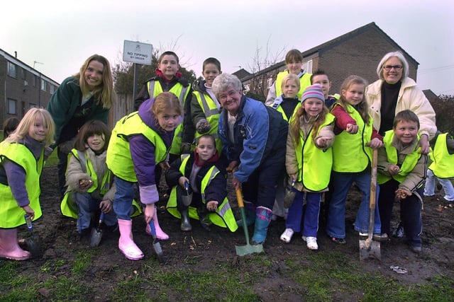 Blub planting on the Rossefield estate in December 2003. Pictured with pupils of St Peters C of E School, are Audrey Maskill, chair of the Rossefield Residents Association, Coun Denise Atkinson, right, and warden Michelle  Fisher, left.