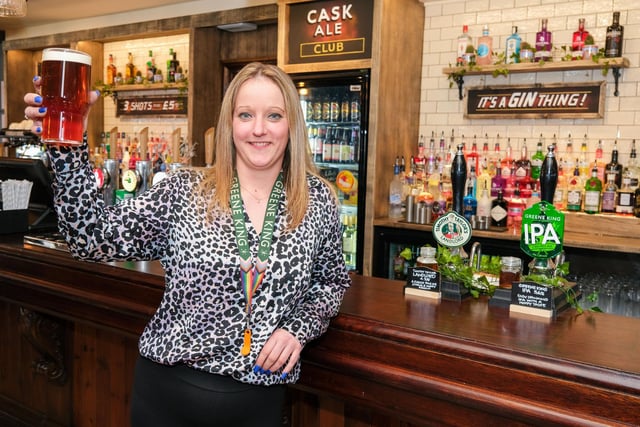 Manager Sarah Gill raises a glass after welcoming back pub regulars.