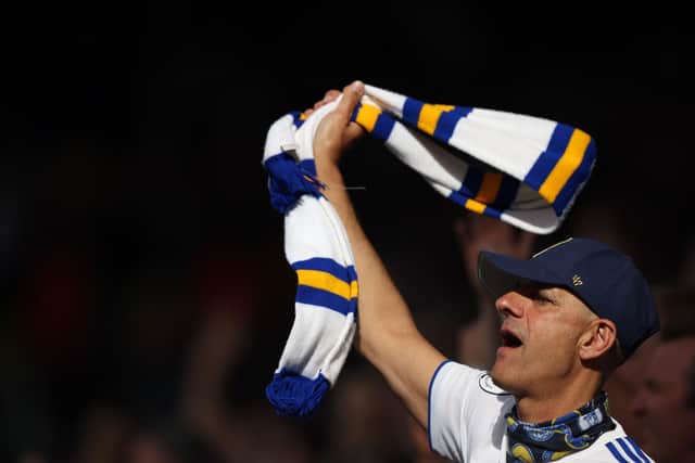 LEEDS, ENGLAND - AUGUST 06: A Leeds United fans waves a scarf during the Premier League match between Leeds United and Wolverhampton Wanderers at Elland Road on August 6, 2022 in Leeds, United Kingdom. (Photo by Marc Atkins/Getty Images)