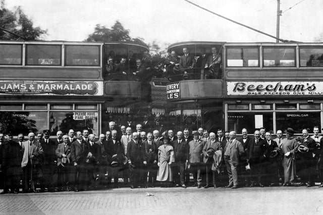 The opening of electric tramways, constructed on private right of way, between Harehills and Canal Gardens, Roundhay in July 1923. The photo shows two trams in the background and a large crowd of people in the front posing for the photograph.