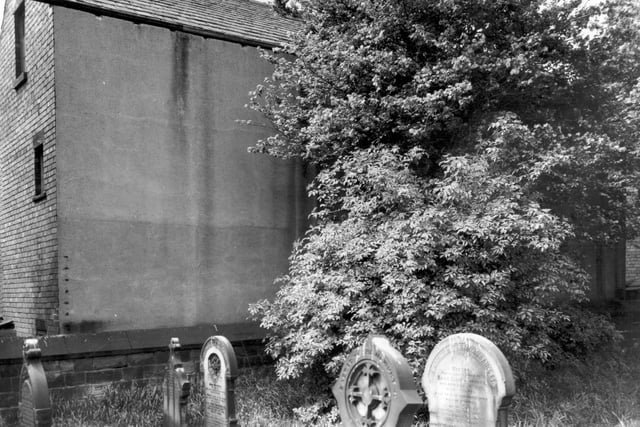 Five gravestones in St. Bartholomew's Church burial ground, with the backs of houses on Cricketers Place in the background. Pictured in June 1965.