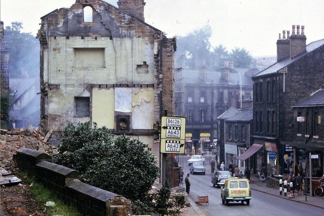 Scatcherd Hill looking towards Morley Bottoms in September 1966. Demolition of the buildings on the left hand side of the road is taking place in preparation for the road widening which it was expected would ease traffic congestion in this part of the town. These buildings, with their backs on Dawson Hill, were a strange mixture in architectural terms and dated from 1848. At one time there was a tombstone shop and a pawnbroker.