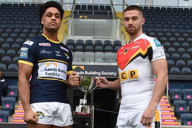 Rhinos' new signing Derrell Olpherts and Bulls' former Leeds full-back Jack Walker with the Keith Howard Foundation Trophy which the teams will play for on Sunday. Picture by Matthew Merrick Photography/Leeds Rhinos.