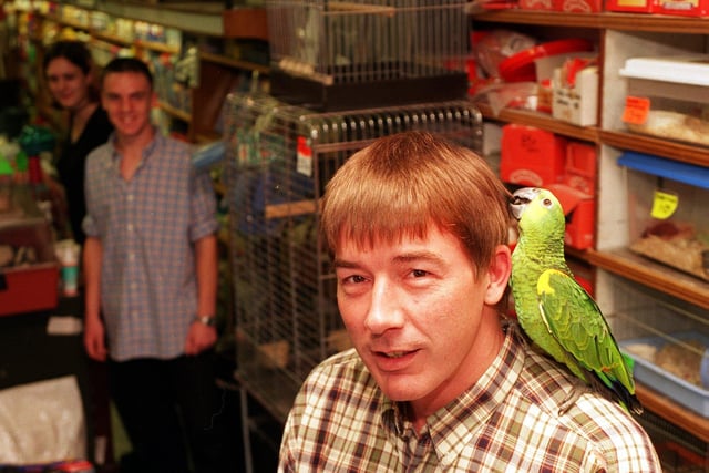 Pets and Aquaria in the Grand Arcade on Upper Briggate.  Owner Geoff Birch is pictured in September 1999 with a parrot called Hughie, and shop assistants Katheryn Tomlinson and Steve Kirk. The shop was started by Geoff's grandfather in 1938.