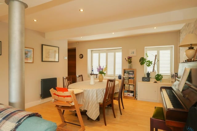 A generous living and dining room is flooded with natural light in the day and would make the perfect entertaining space in the evening. It has two cast iron style radiators and fitted venetian blinds.