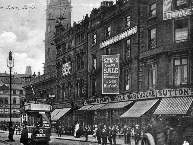 The north side of Boar Lane from a postcard with postmark September 27, 1907. On the right is Sutton's London & Paris Mantle Warehouse which is advertising a summer sale. Above this is the photographic studio of Arthur Thawley, who describes his products as 'Thawley's Good & Artistic Photos'. Further along are the premises of Mrs. Melbourne, costumier, then Holy Trinity Church. After the junction with Trinity Street is the Grand Pygmalion, the department store owned by Monteith, Hamilton & Monteith Ltd.