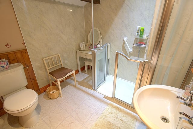 A walk-in shower with fitted seat forms part of the shower room suite.