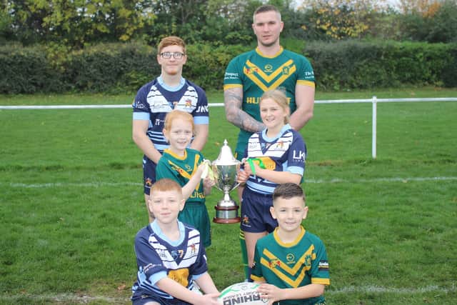 Players from Hunslet Warriors and Hunslet Club Parkside open age, girls' and junior sections with the National Conference Premier Division trophy. Picture by Hunslet ARLFC.