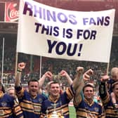 The banner says it all as Rhinos celebrate.