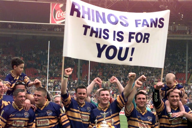 The banner says it all as Rhinos celebrate.