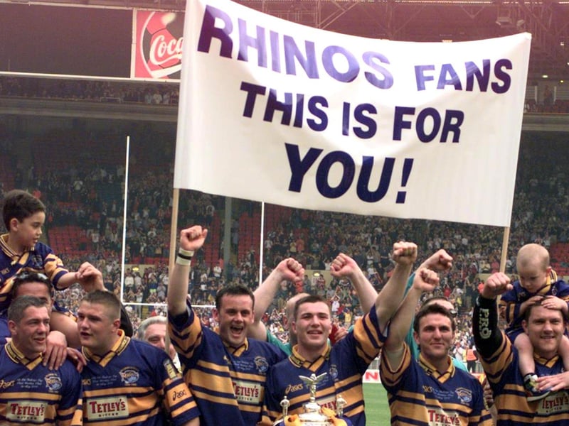 The banner says it all as Rhinos celebrate.