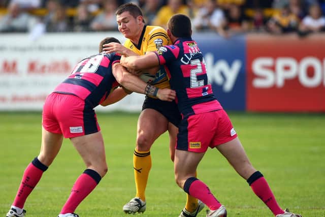 Brett Ferres in action for Castleford Tigers agianst Leeds Rhinos in 2011. The tacklers are Luke Burgess and Chris Clarkson. Picture by Vaughn Ridley/SWpix.com.