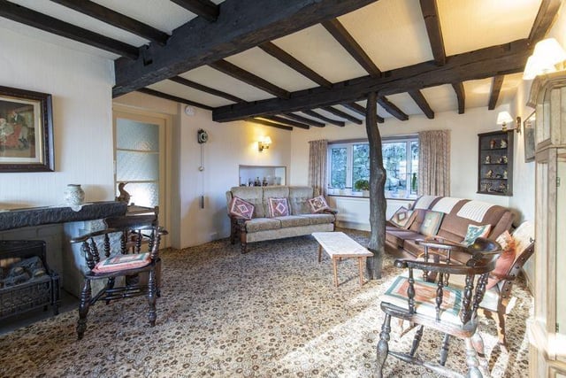 The charming interior of the listed farmhouse, with exposed beams.