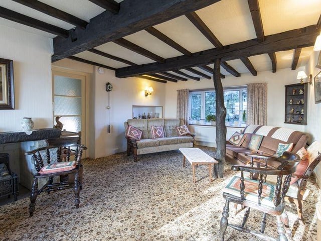 The charming interior of the listed farmhouse, with exposed beams.