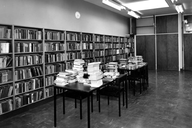 The staff work room in the brand new Seacroft Branch Library. Piles of books are waiting to be processed. This may involve pasting in a new date label or a spine label or perhaps fitting a new jacket. Older books would be brought in here for cleaning or minor repairs. The photograph was taken the year the library opened in 1964.