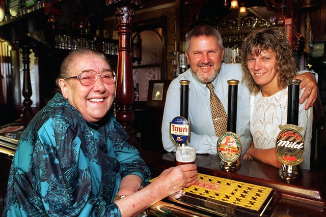 Majorie Farnsworth (left) enjoys  a drink in the Cardigan Arms on Kirkstall Road, Leeds, with the landlord and landlady Barrie and Janet Edmonds.