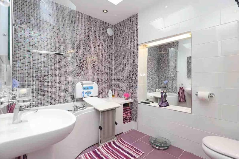 This bathroom adds a touch of sparkle with its gleaming tiles.
