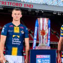 Leeds Rhinos' Ash Handley and Ben Currie, of Warrington Wolves, with the Betfred Super League trophy at Old Trafford. Picture by Allan McKenzie/SWpix.com.