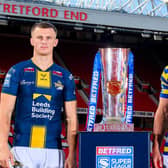 Leeds Rhinos' Ash Handley and Ben Currie, of Warrington Wolves, with the Betfred Super League trophy at Old Trafford. Picture by Allan McKenzie/SWpix.com.
