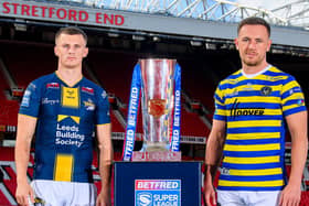 Leeds Rhinos' Ash Handley and Ben Currie, of Warrington Wolves, with the Betfred Super League trophy at Old Trafford. Picture by Allan McKenzie/SWpix.com.