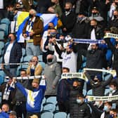 LEEDS, ENGLAND - MAY 23: Leeds fans support their team during the Premier League match between Leeds United and West Bromwich Albion at Elland Road on May 23, 2021 in Leeds, England. (Photo by Stu Forster/Getty Images)