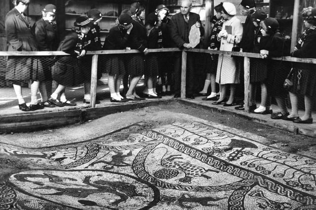 Rudston in October 1961. Henry Robson shows a party of schoolchildren one of the magnificent pavements in the Roman Villa he found while ploughing on the Yorkshire Wolds in April 1933.