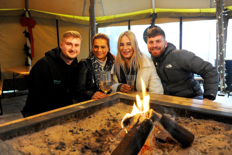 Lewis Pickles, Niamh Kelly, Molly Southwaite and James Barber, pictured keeping warm and enjoying a drink in Thor's Tipi Bar on The Headrow.