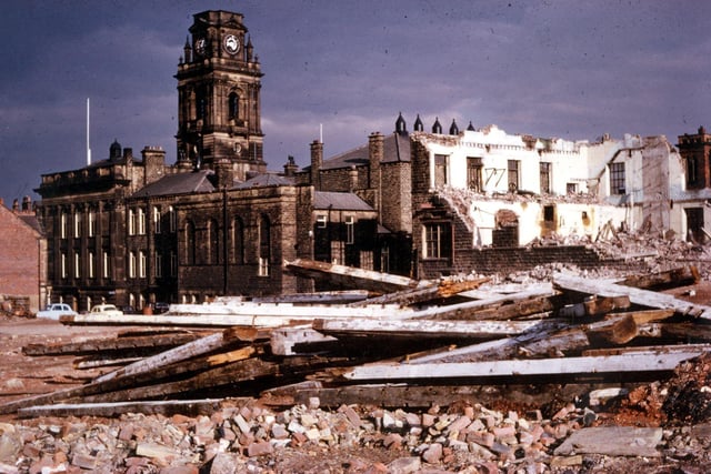 This photograph shows the final stages of the demolition of the Queen's and Albert Mills, long situated behind Morley Town Hall. The timbers at the front of the image appear somewhat charred as these are from the Albert Mill, which, in August 1961, was the source of the fire which ultimately destroyed the dome of the Town Hall tower. Work on the restoration of the dome did not begin until May 1962 and took the rest of the year. The Town Hall did not lose its black, grimy appearance until late 1972 and early 1973 when several of Morley's public buildings were sandblasted before the local government merger with Leeds.