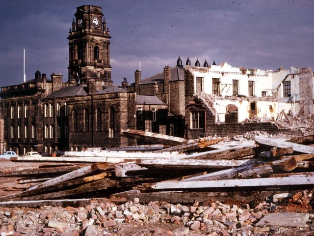 This photograph shows the final stages of the demolition of the Queen's and Albert Mills, long situated behind Morley Town Hall. The timbers at the front of the image appear somewhat charred as these are from the Albert Mill, which, in August 1961, was the source of the fire which ultimately destroyed the dome of the Town Hall tower. Work on the restoration of the dome did not begin until May 1962 and took the rest of the year. The Town Hall did not lose its black, grimy appearance until late 1972 and early 1973 when several of Morley's public buildings were sandblasted before the local government merger with Leeds.