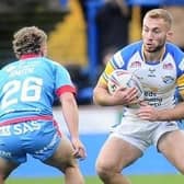 Rhinos' Jarrod O'Connor takes on Harvey Smith, of Wakefield, during Leeds' win on Boxing Day. Picture by Steve Riding.